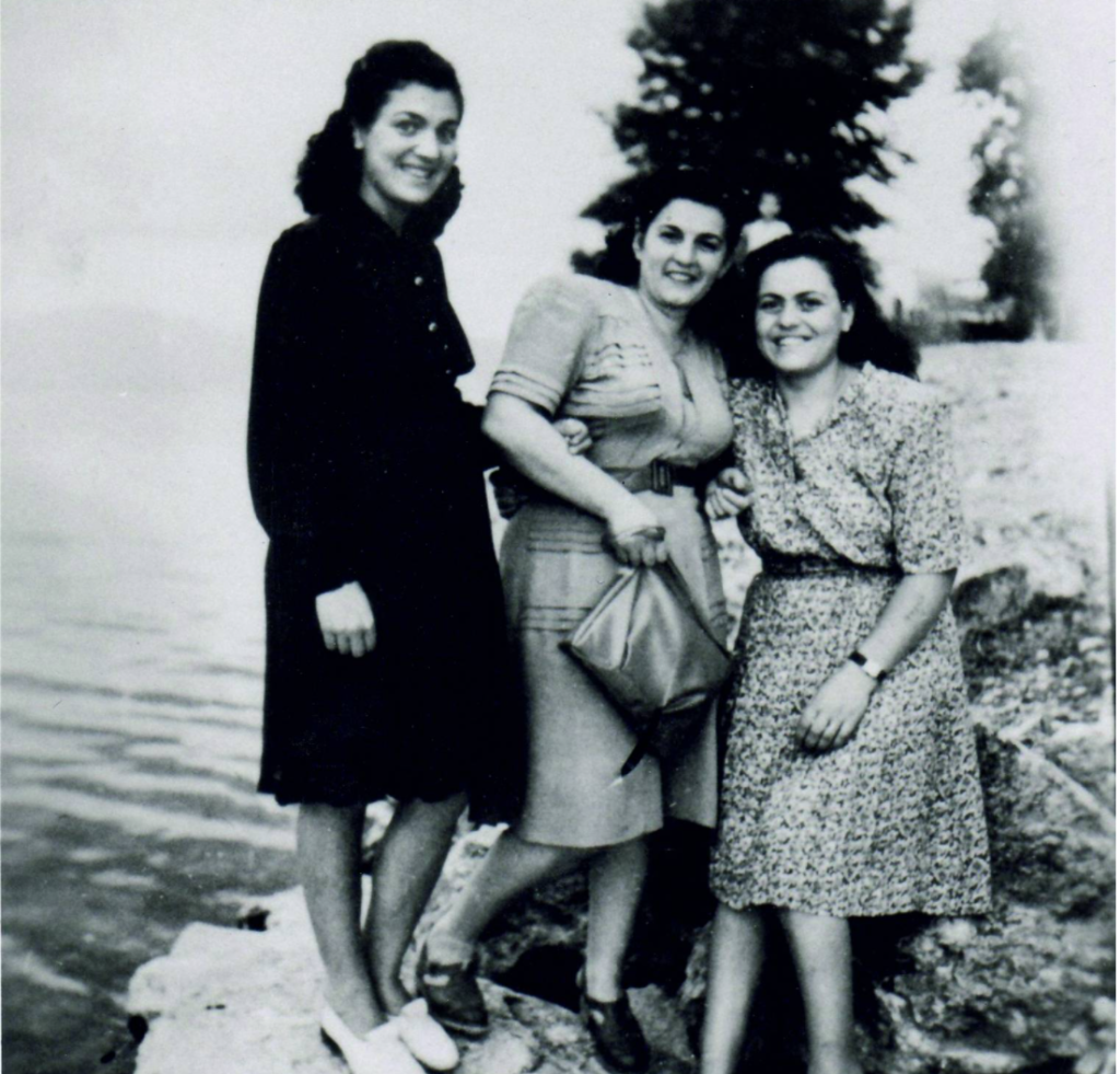 In this photograph, three young women from Ioannina, who survived Ausschwitz's concentration camp, celebrate their home-coming at Kyra Frosini's.